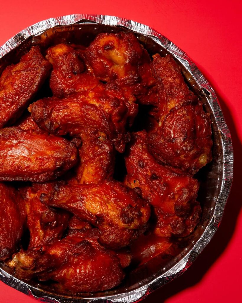 Plate of saucy buffalo chicken wings from Manny & Olga’s.