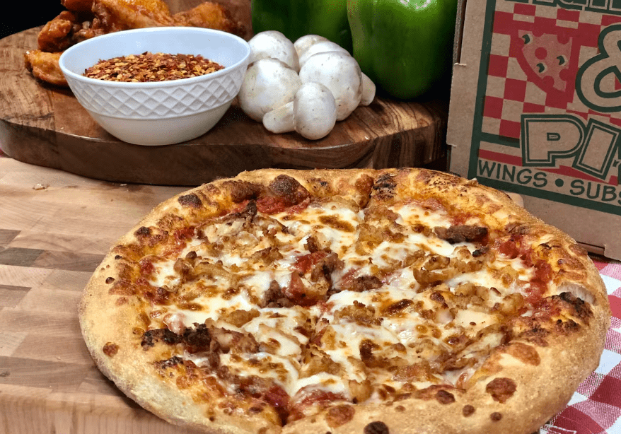 A delicious pizza A delicious pizza with a variety of pizza toppings, including chicken and mushrooms.