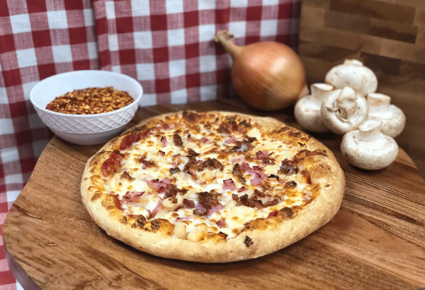 A large, cheesy pizza with a variety of toppings, perfect for sharing with friends and family A large, cheesy pizza with a variety of toppings, including mushrooms, olives, peppers, and tomatoes. calzone and pizza