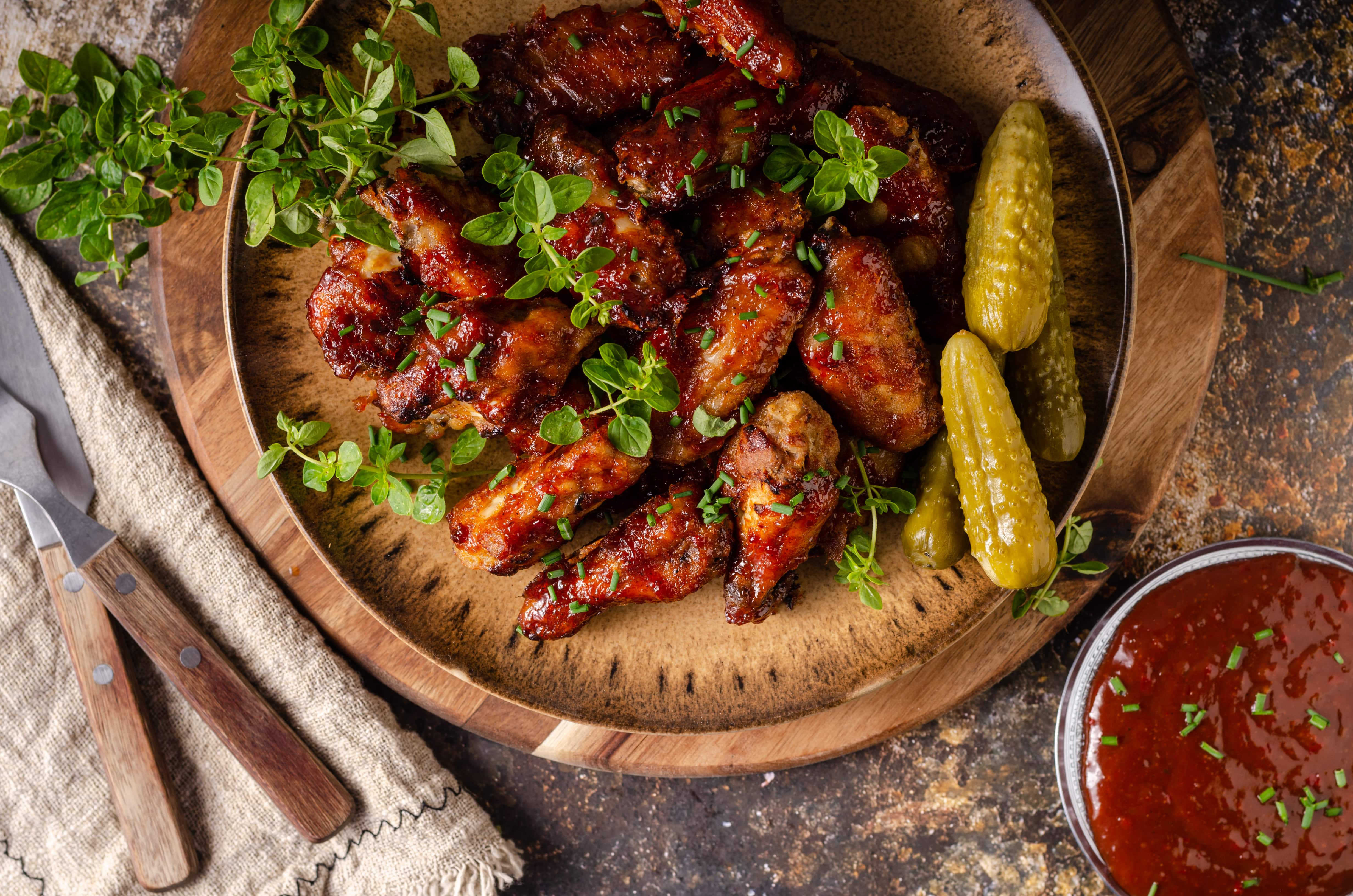 Barbecue wings served with pickles and sauce, showcasing wings in Hill East.