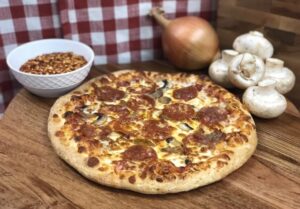 A delicious pizza with a variety of pizza toppings, including pepperoni, mushrooms, and sausage.