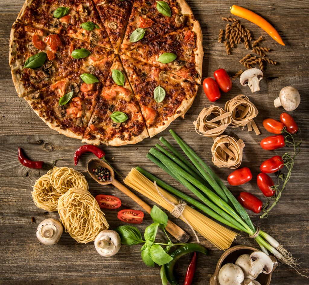 Fresh veggie pizza with all its raw ingredients on display.