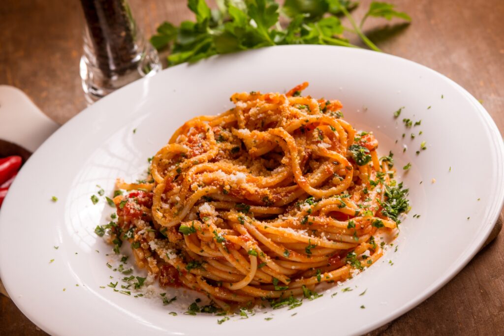 Close-up shot of spicy Arrabbiata pasta on a plate.