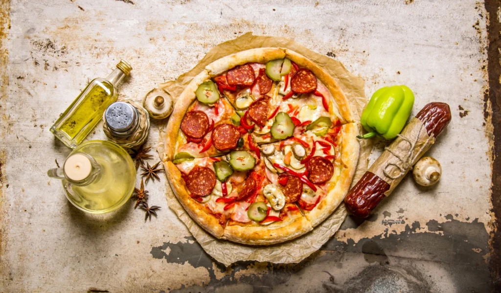 Shot of a delicious topping-rich pizza with salami, peppers, and mushrooms.