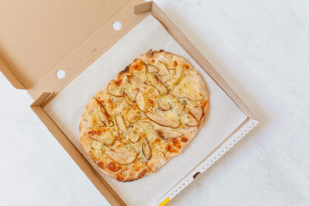 Fresh cheesy pizza delivered in a pizza box.