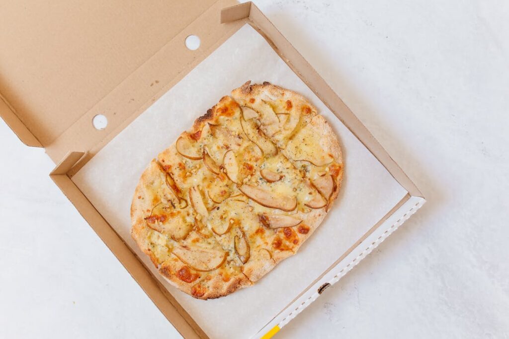 Hot cheese pizza in an open delivery box, perfect for Easter brunch after church service.
