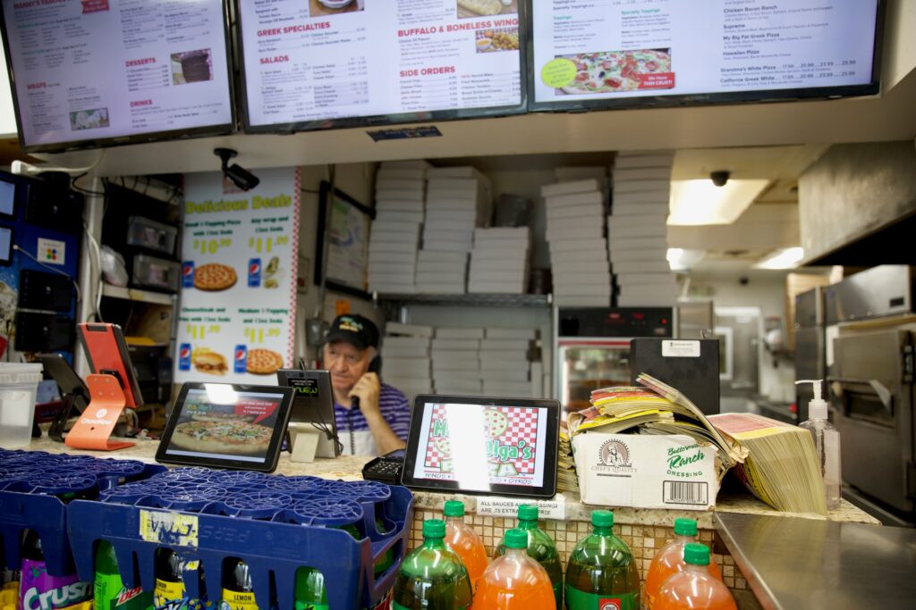 Chef taking orders at Manny & Olga's kitchen counter.