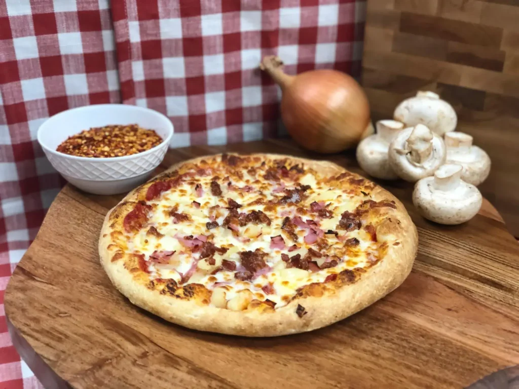 Manny & Olga’s Hawaiian pizza topped with ham and pineapple, a playful and tropical Mother’s Day treat.