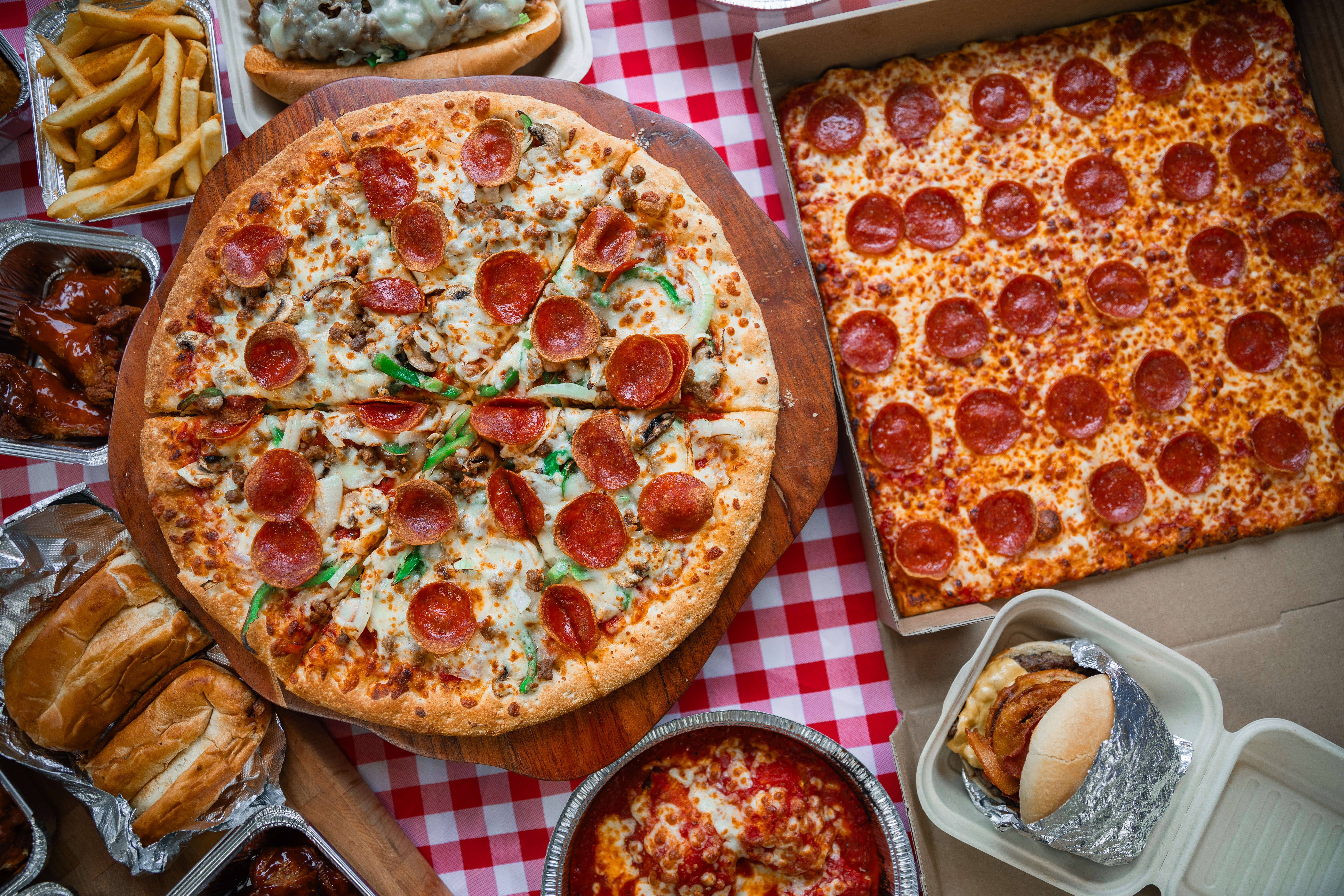 Table displaying Manny & Olga’s pizzas, pasta, and fries.