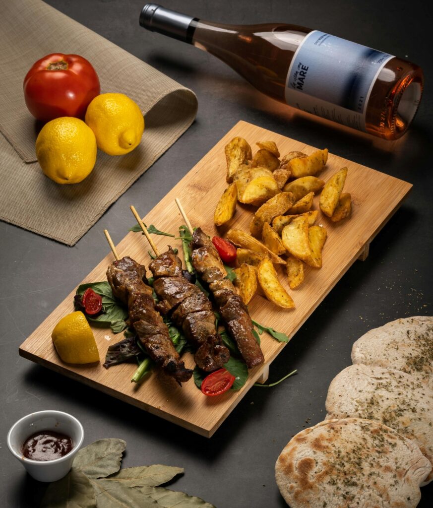 Greek Souvlaki with potato wedges, bread and wine.