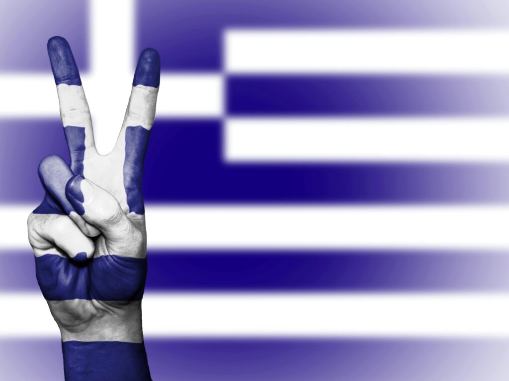 Peace sign against the Greek Flag.