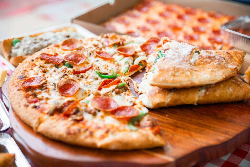 Pepperoni pizza, calzone, and sides from Manny & Olga’s Pizza for office catering in Washington, D.C.