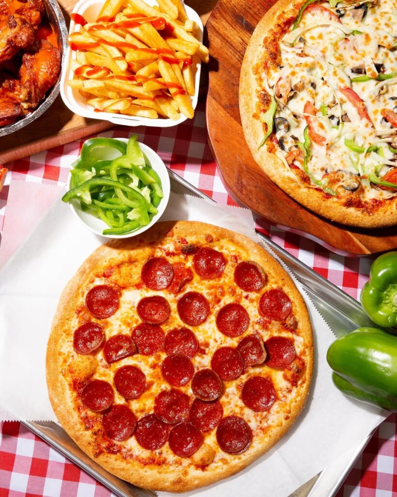 Pepperoni pizza, veggie pizza, fries, and wings from Manny & Olga’s menu