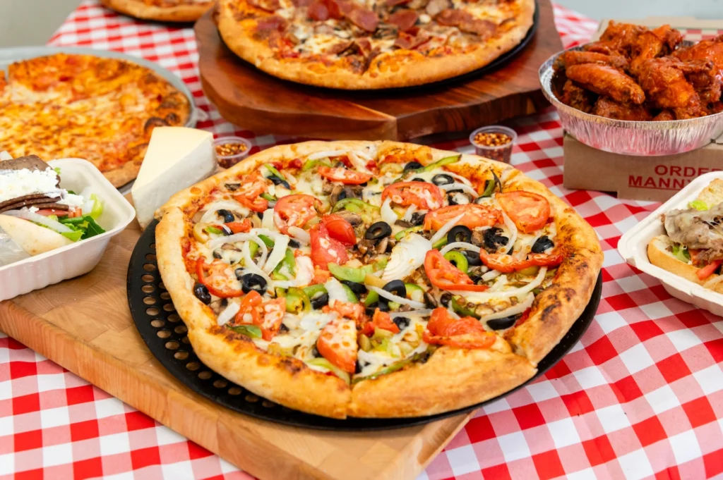 Manny & Olga’s veggie pizza served with cheese pizza, wings, gyro, and a cheesesteak sub.