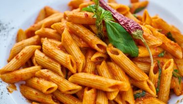 Close-up shot of spicy penne pasta.
